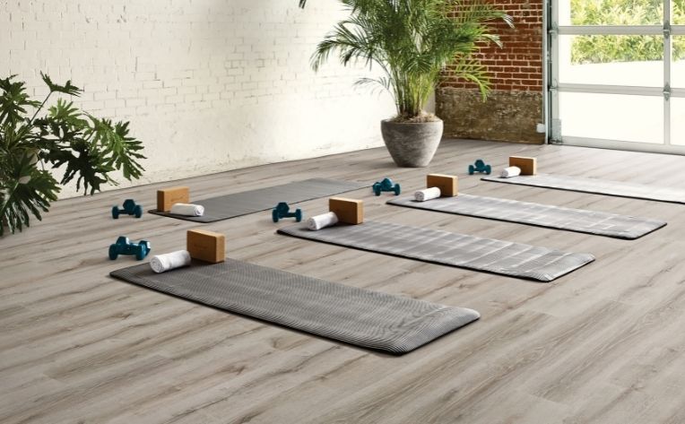 workout room with yoga mats and barbells 