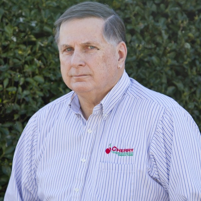 David Haywood headshot in front of green bush