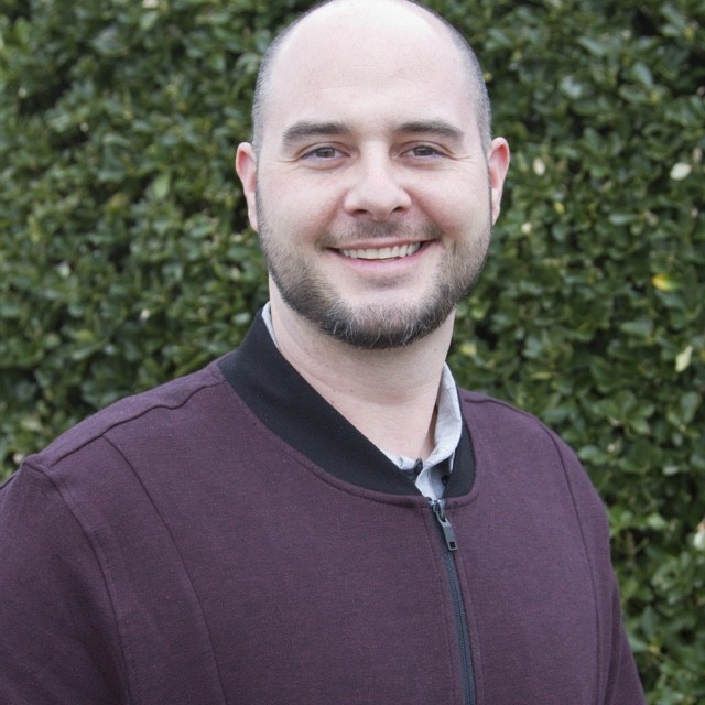 Eric Thorstensen headshot in front of green bush