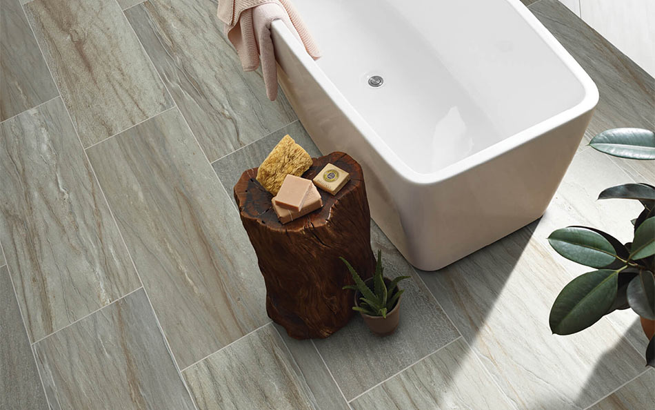 Aerial tile room scene with white bathtub and wood side table