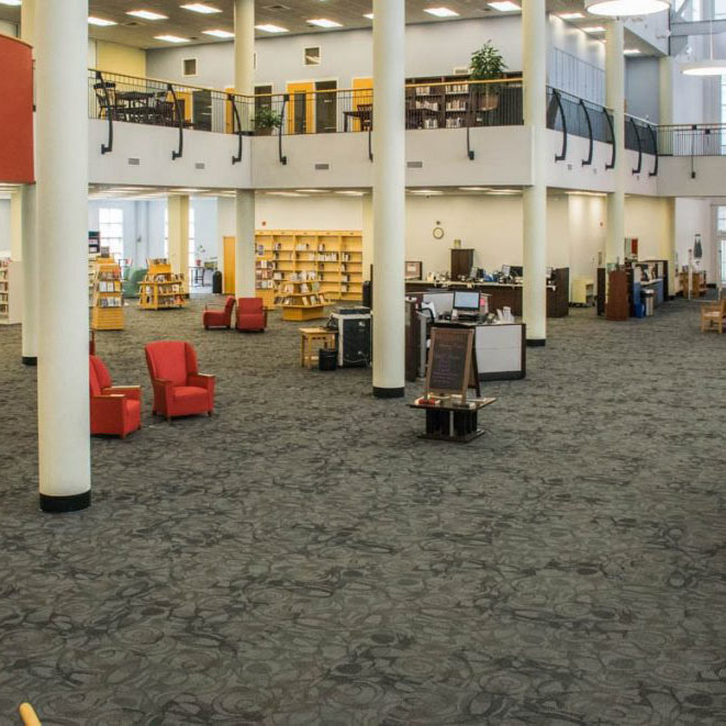 Spacious library interior with gray patterned flooring