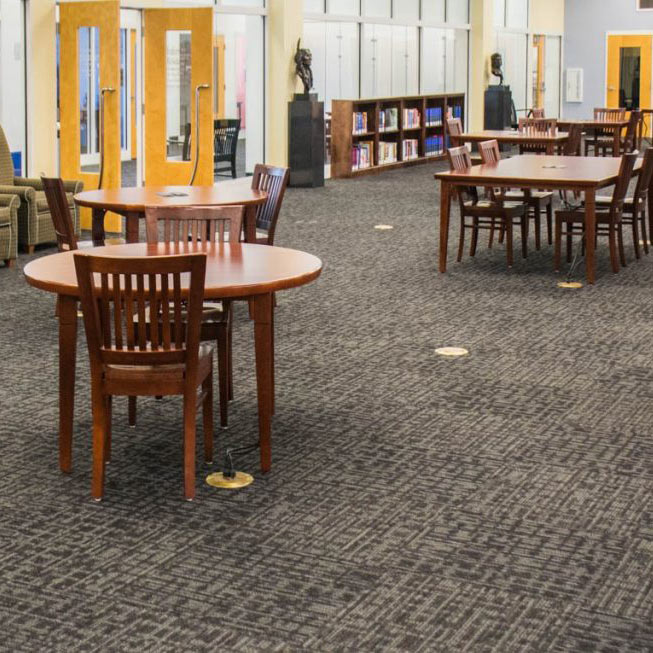 Spacious library interior with gray patterned flooring