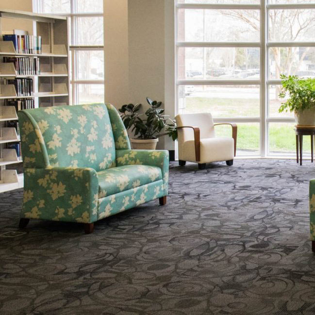 Spacious library interior with gray patterned flooring