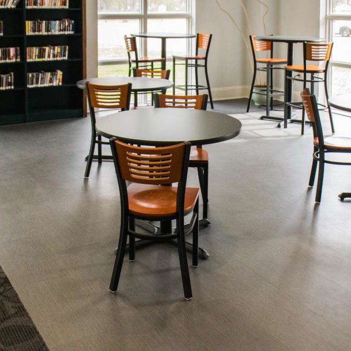 Spacious library interior with gray patterned flooring