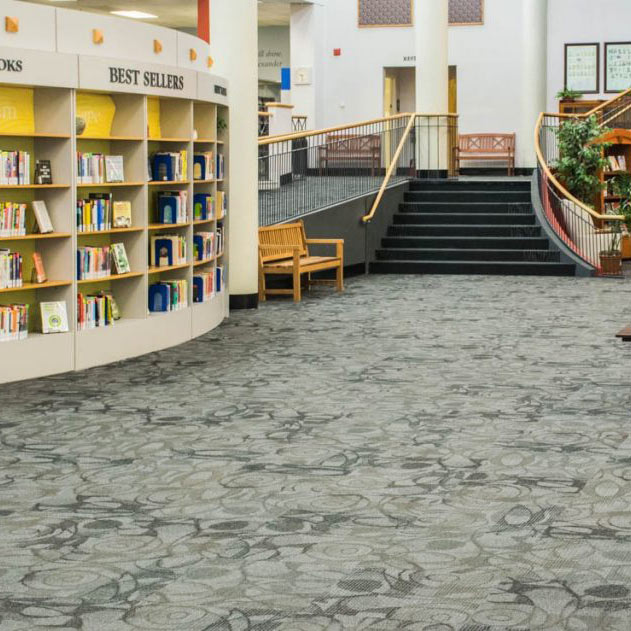 Spacious library interior with gray patterned flooring