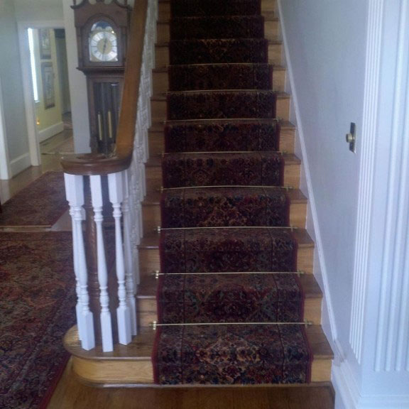 Stairs red patterned carpet room scene