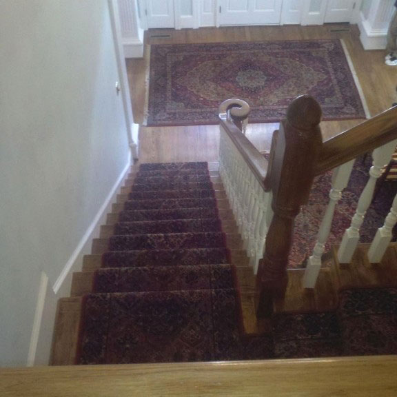 Stairs red patterned carpet room scene