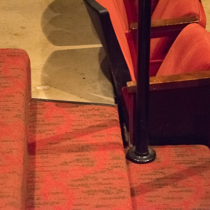 Commercial theater interior with bright red carpet