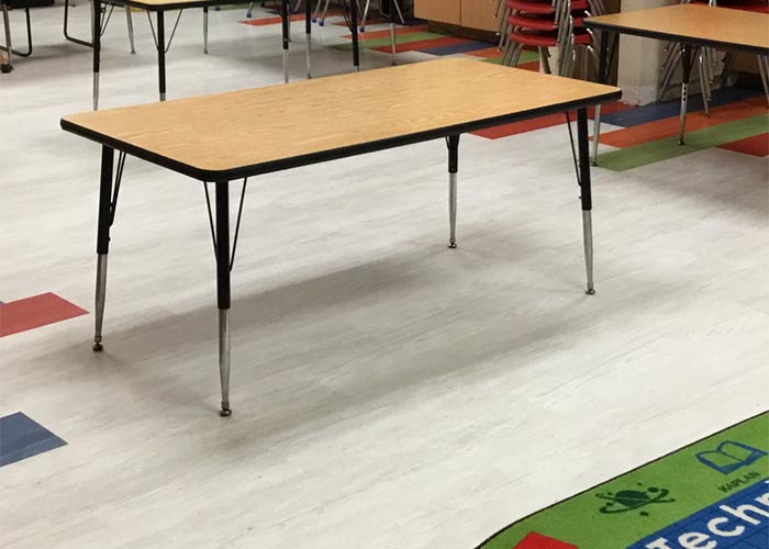 Interior classroom with tables, chairs and new flooring