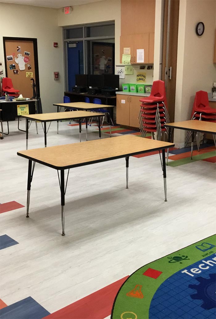 Interior classroom with tables, chairs and new flooring