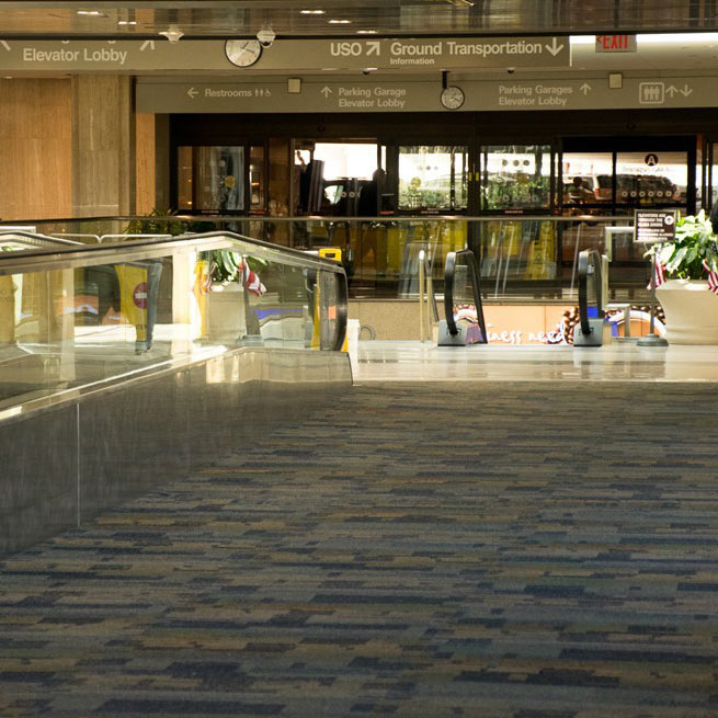 Spacious library interior with patterned carpet and hard surface flooring