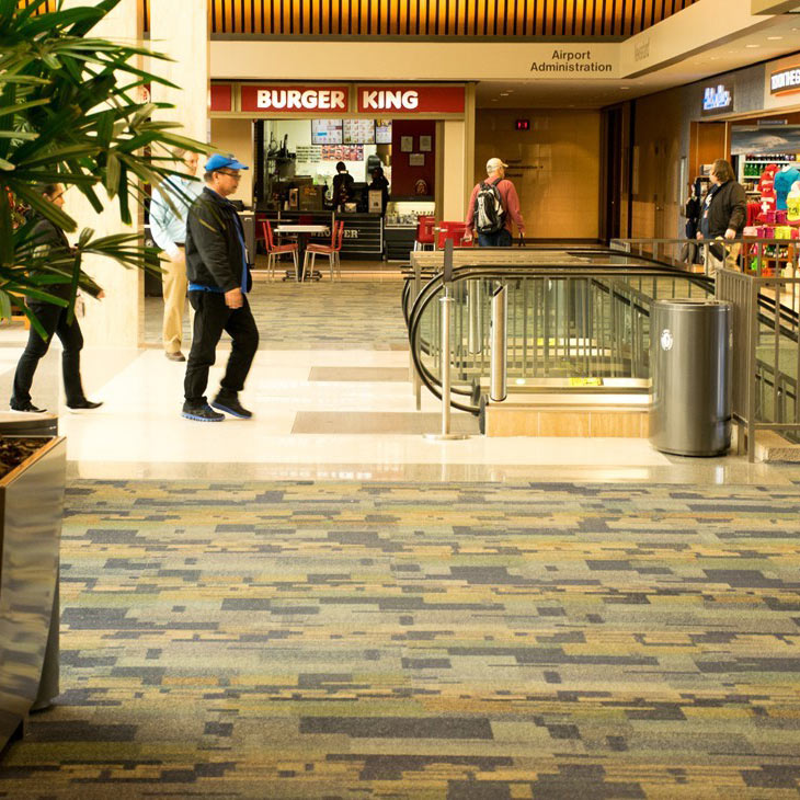 Spacious library interior with patterned carpet and hard surface flooring