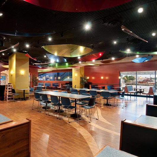 Fun restaurant interior with wood-look floors and colorful ceiling