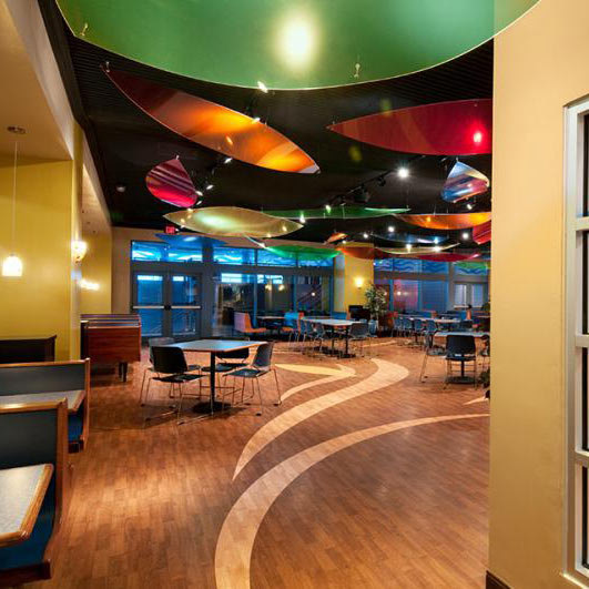 Fun restaurant interior with wood-look floors and colorful ceiling