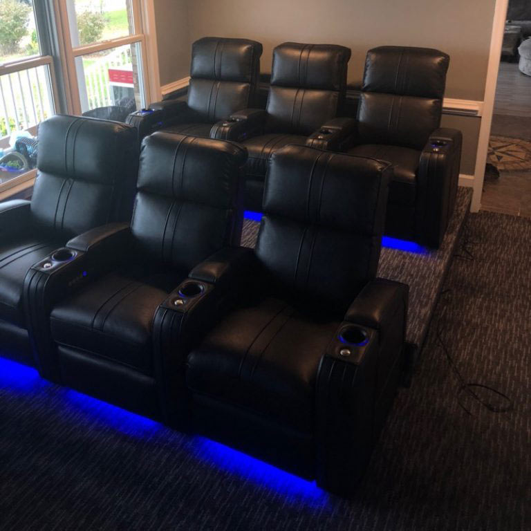 Home theater room with dark patterned carpet