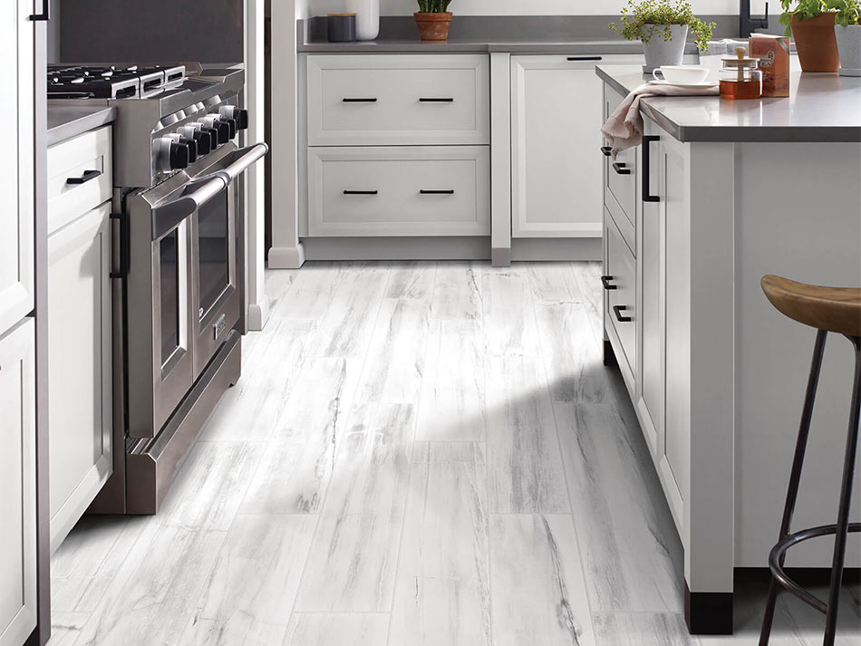 Kitchen room scene with white luxury vinyl flooring and white cabinets